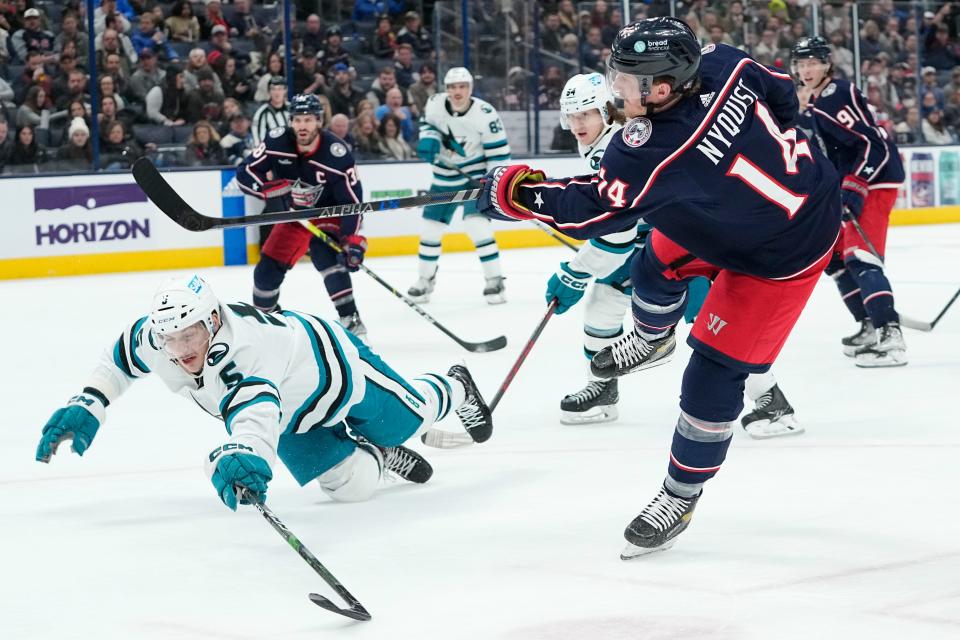 Jan 21, 2023; Columbus, Ohio, USA;  Columbus Blue Jackets left wing Gustav Nyquist (14) scores the game winning goal past San Jose Sharks defenseman Matt Benning (5) during the third period of the NHL hockey game at Nationwide Arena. The Blue Jackets won 5-3. Mandatory Credit: Adam Cairns-The Columbus Dispatch