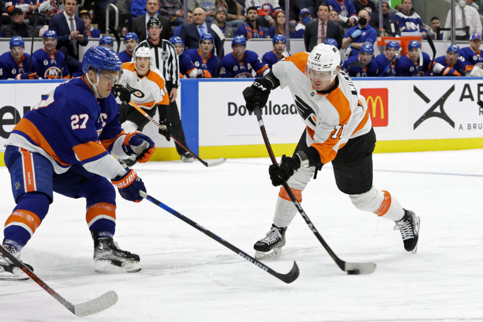 Philadelphia Flyers center Max Willman (71) shoots as New York Islanders left wing Anders Lee (27) defends during the first period of an NHL hockey game, Tuesday, Jan. 25, 2022, in Elmont, N.Y. (AP Photo/Corey Sipkin)