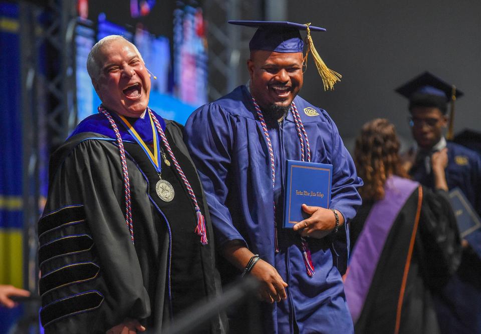 Indian River State College President Timothy Moore (left) and graduate Trevor Howard celebrate on the stage during the college's Fall Commencement Ceremony for Associate in Art Degrees on the morning of Wednesday, Dec. 13, 2023, inside the Havert L Fenn Center in Fort Pierce. "These kids are coming out of a COVID pandemic, they persevered, they're here, they're moving on with their lives, they're getting ready to become work force amplifiers for the State of Florida," Moore said. "We're very excited for them, almost 96 percent are graduates are getting ahead without debt, so we can transform their lives without putting an anchor around them called student loan debt and now they're going to go off and do great things.' IRSC handed out diplomas and awards to 2,070 students, 962 Associate degrees, 468 Bachelors degrees and 640 certificates, vocational certificates and advanced technology diplomas during the two days of ceremonies.