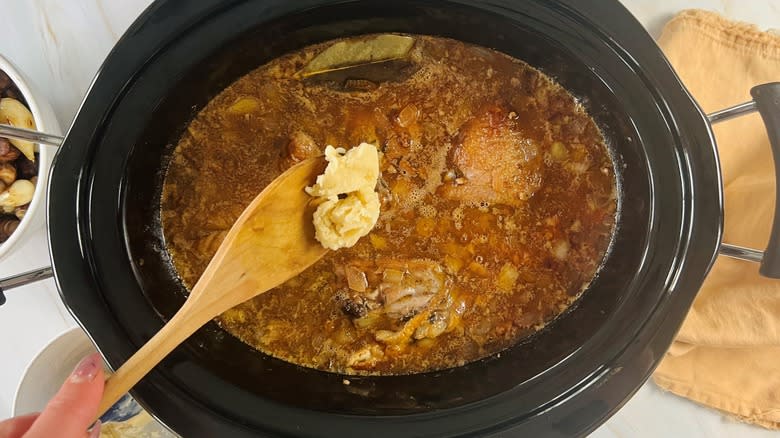adding butter paste to crockpot