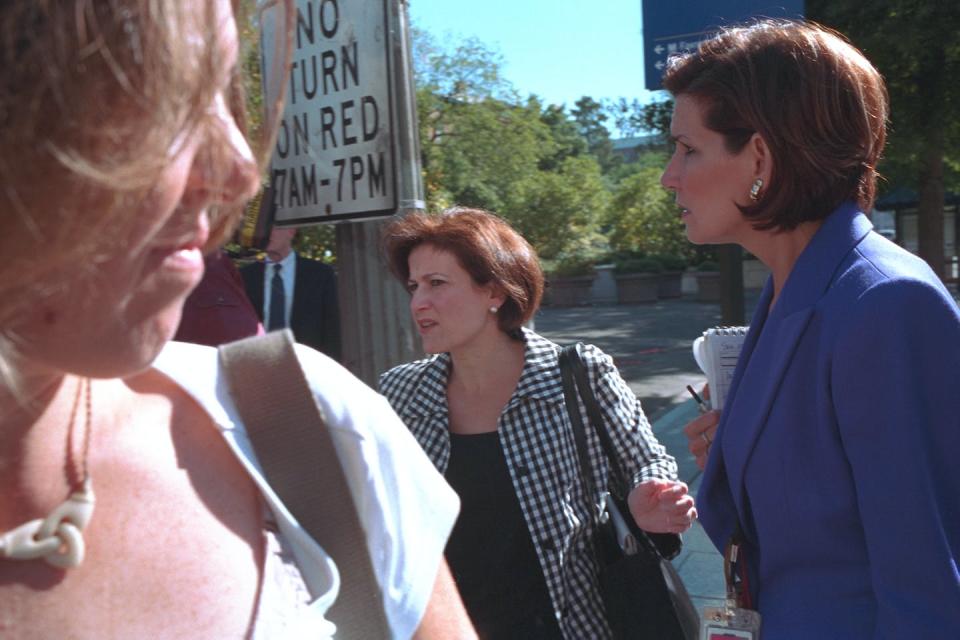 Women staffers were advised to kick off their heels to get out of the White House faster. Here, Anita McBride, left, and Mary Matalin, right, on Pennsylvania Avenue. George W. Bush Presidential Center