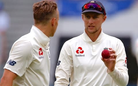 Root handles the ball carefully to try to keep it dry - Credit: REUTERS/David Gray