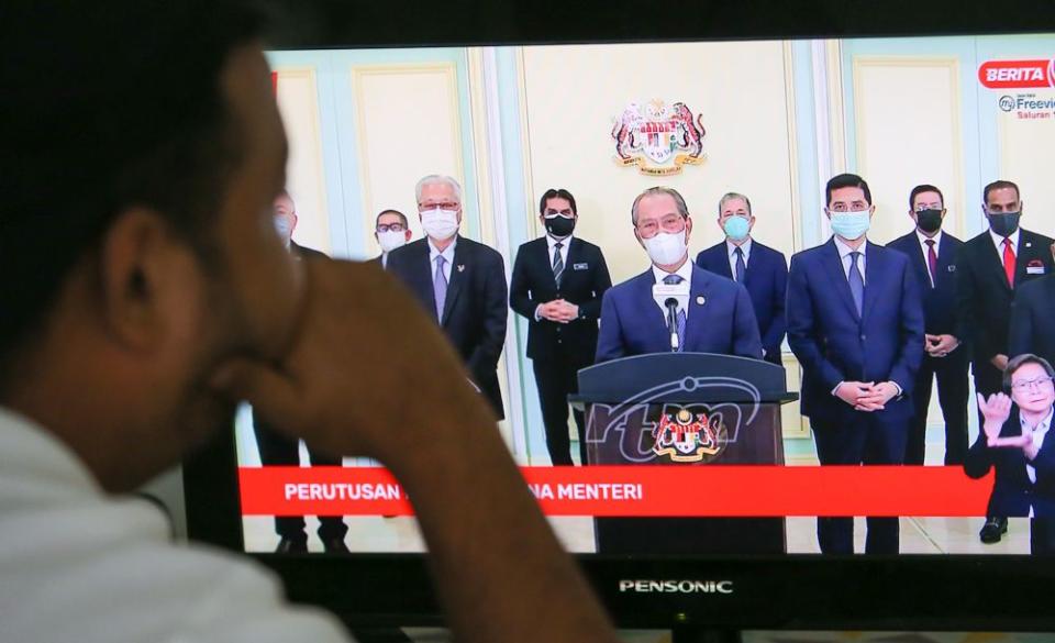 A man watches a live telecast of Prime Minister Tan Sri Muhyiddin Yassin’s speech in Ipoh August 4, 2021. — Picture by Farhan Najib