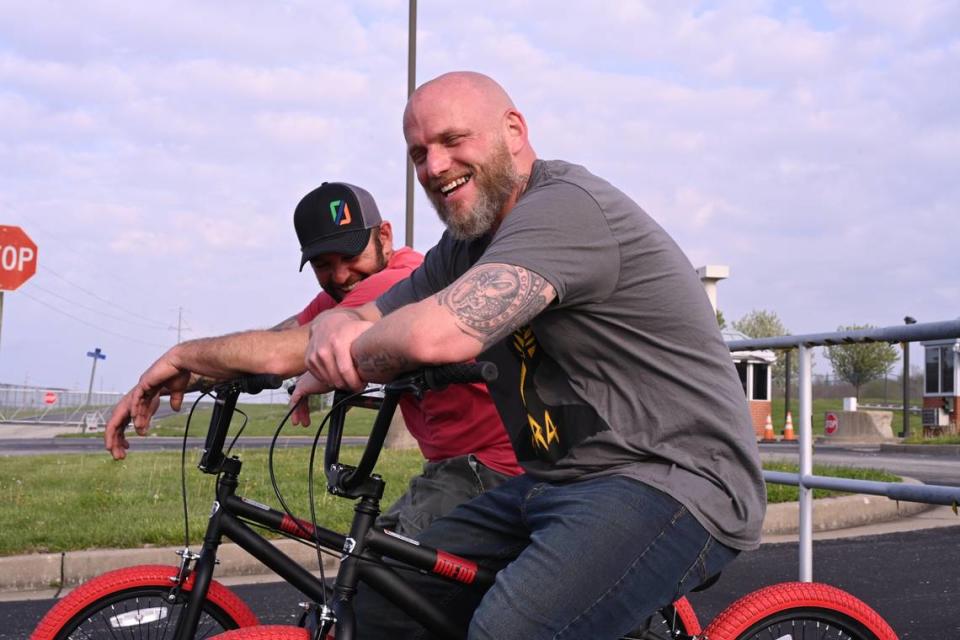 Michael Politte and his childhood friend Mike Glore ride bikes after Politte was paroled April 22, 2022. He spent more than two decades in prison for a murder that he maintains he did not commit.