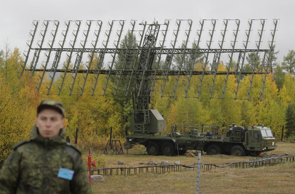 A Russian soldier stands in front of a Nebo-M radar deployed in a forest, during a military exercises on training ground "Telemba", about 80 kilometers (50 miles ) north of the city of Chita during the military exercises Vostok 2018 in Eastern Siberia, Russia, Wednesday, Sept. 12, 2018. Hundreds of thousands Russian troops swept across Siberia on Tuesday in the nation's largest ever war games also joined by China — a powerful show of burgeoning military ties between Moscow and Beijing amid their tensions with the U.S. (AP Photo/Sergei Grits)