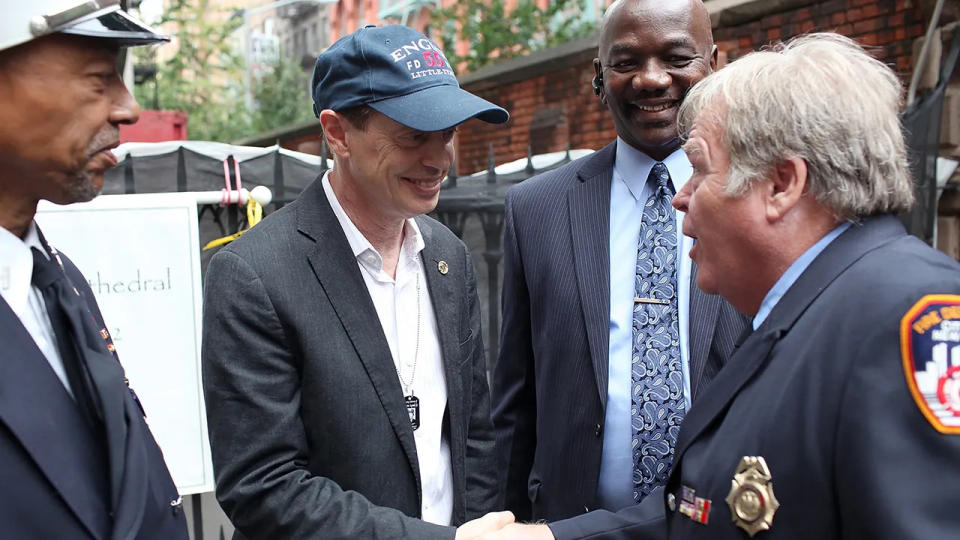 Steve Buscemi shaking hands with New York firefighters