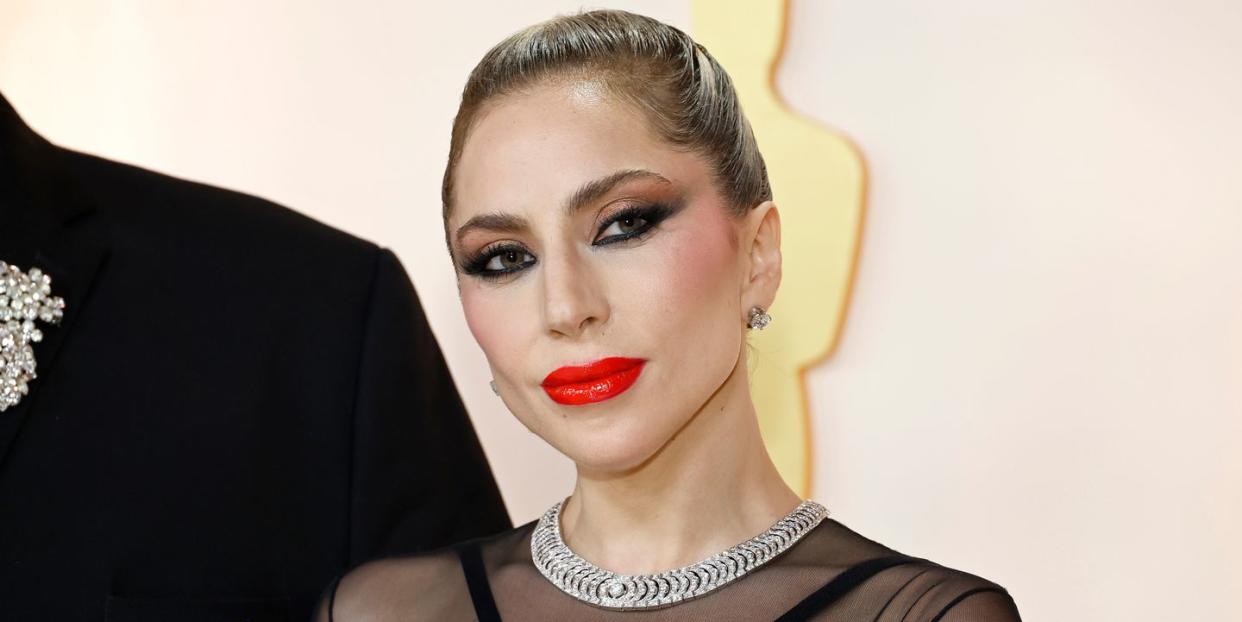 lady gaga at the oscars 2023 red carpet, red lipstick, black eyeliner