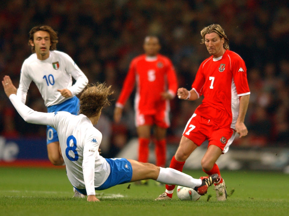 CARDIFF - OCTOBER 16:  Massimo Ambrosini (No.8) of Italy tackles Robbie Savage of Wales during the 2004 European Champioship Group 9 Qualifying match between Wales and Italy on October 16, 2002 played at the Millennium Stadium in Cardiff, Wales. Wales won the match 2-1. (Photo by Shaun Botterill/Getty Images).