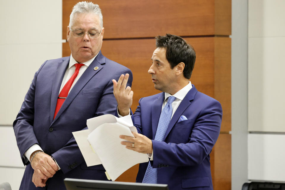 Former Marjory Stoneman Douglas High School School Resource Officer Scot Peterson, left, and his defense attorney Mark Eiglarsh speak during Peterson's trial at the Broward County Courthouse in Fort Lauderdale on Tuesday, June 20, 2023. Broward County prosecutors charged Peterson, a former Broward Sheriff's Office deputy, with criminal charges for failing to enter the 1200 Building at the school and confront the shooter as he perpetuated the Valentine's Day 2018 Massacre that left 17 dead and 17 injured. (Amy Beth Bennett/South Florida Sun-Sentinel via AP, Pool)