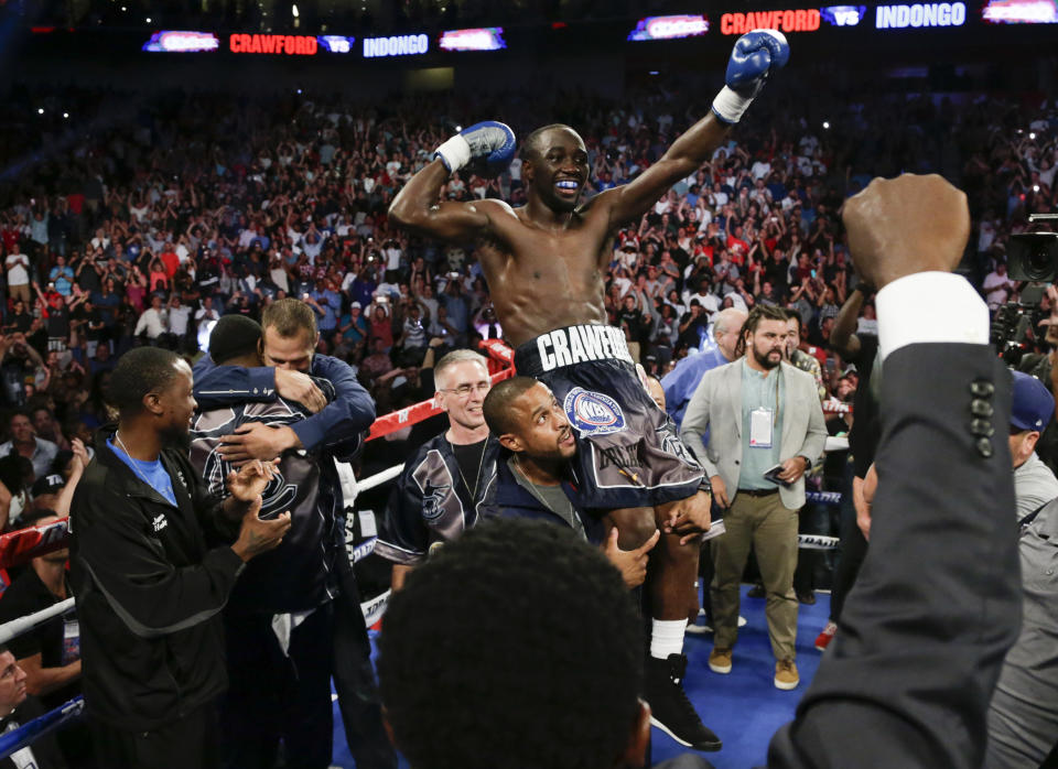 Terence “Bud” Crawford celebrates his third-round knockout victory of Julius Indongo Saturday in Lincoln, Neb., that made him the undisputed super lightweight champion. (AP Photo/Nati Harnik)