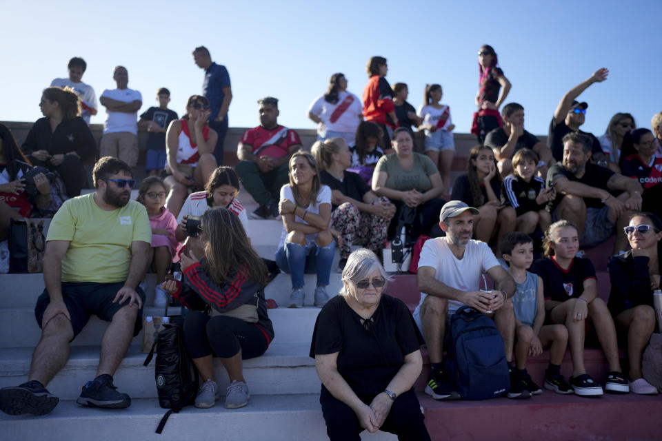 Fans wait for the start of a women's professional soccer match between River Plate and Boca Juniors in Ezeiza on the outskirts of Buenos Aires, Argentina, Sunday, March 10, 2024. A growing group of foreigners are joining the Argentinian league as it seeks to boost its recently turned professional women's soccer teams. (AP Photo/Natacha Pisarenko)