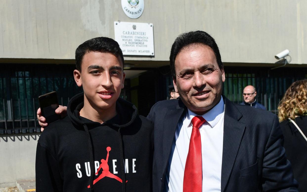 School boy Rami Shehata pretended to be praying in Arabic while calling for help during the hijacking of a bus near Milan by its driver. Pictured with his father, Khaled Shehata - AFP