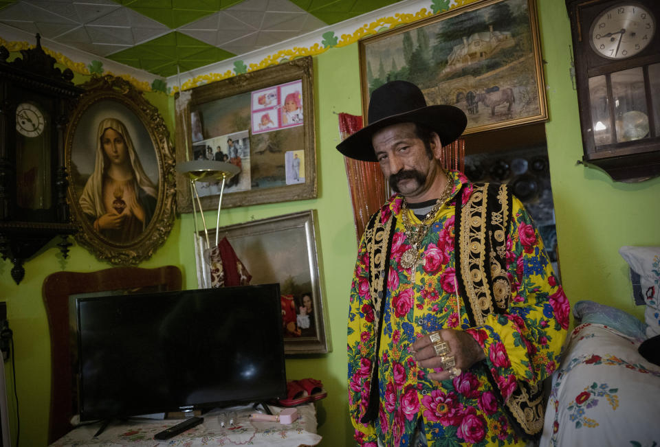 Zoltan Sztojka, traditional Gypsy fortune-teller, is photographed in his home in Soltvadkert, central Hungary, Sunday, Oct. 10, 2021. Sztojka, by his own account Hungary’s last Roma fortuneteller, is working to preserve his culture's traditions that are slowly vanishing in the Central European country. (AP Photo/Bela Szandelszky)