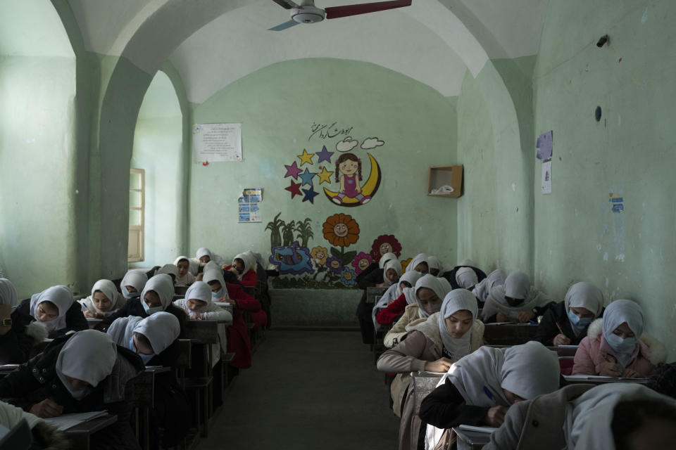 Afghan girls participate a lesson inside a classroom at Tajrobawai Girls High School, in Herat, Afghanistan, Thursday, Nov. 25, 2021. While most high school girls in Afghanistan are forbidden to attend class by the country's Taliban rulers, one major exception are those in the western province of Herat. For weeks, girls there have been attending high school classes, thanks to a unique effort by teachers and parents to persuade local Taliban administrators to allow schools to reopen. (AP Photo/Petros Giannakouris)