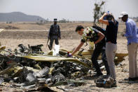 FILE PHOTO: An American family lays flowers for their daughter, who died in the Ethiopian Airlines Flight ET 302 plane crash, after a commemoration ceremony at the scene of the crash, near the town of Bishoftu, southeast of Addis Ababa, Ethiopia March 13, 2019. REUTERS/Baz Ratner