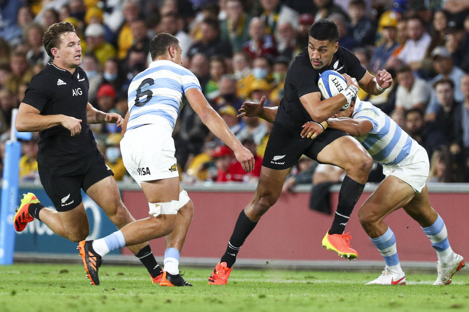 New Zealand's Rieko Ioane runs at the defense during the Rugby Championship test match between the All Blacks and the Pumas in Brisbane, Australia, Saturday, Sept. 18, 2021. (AP Photo/Tertius Pickard)