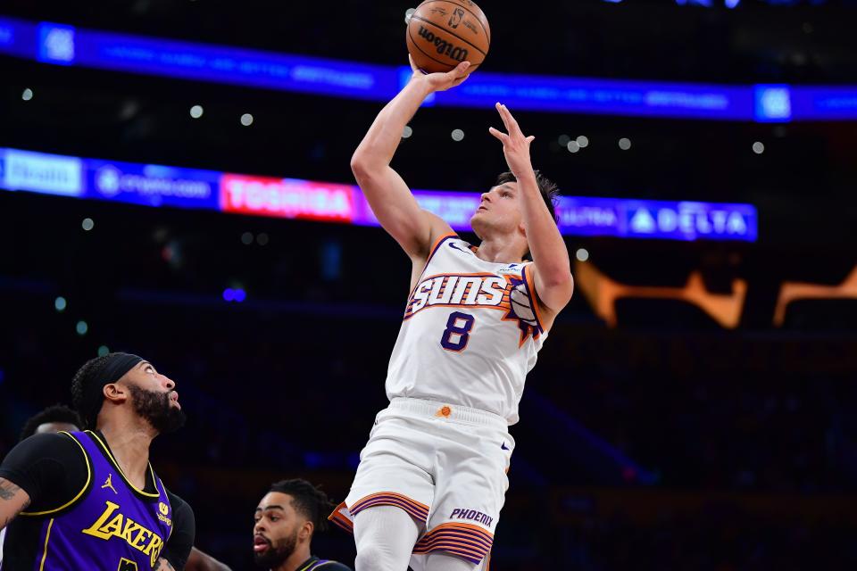 Phoenix Suns guard Grayson Allen (8) shoots against Los Angeles Lakers forward Anthony Davis (3) during the first half at Crypto.com Arena.