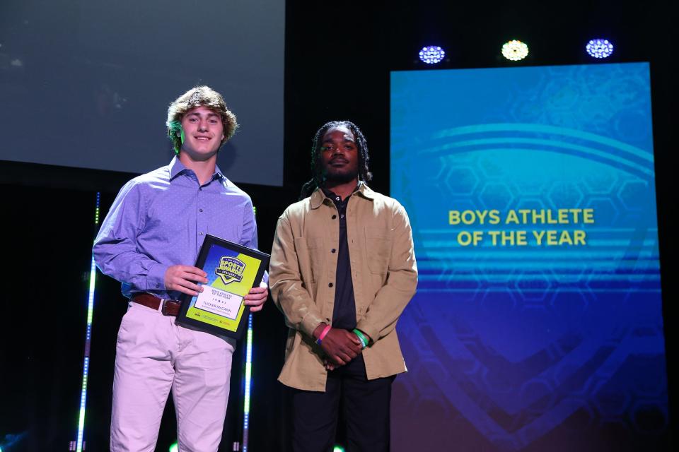 Tucker McCann, left, of Winnacunnet HIgh School, receives the Boys Athlete of the Year honor at the 2022 Seacoast All-Star Sports Awards from sports reporter Brandon Brown at The Music Hall in Portsmouth on Monday, June 20.