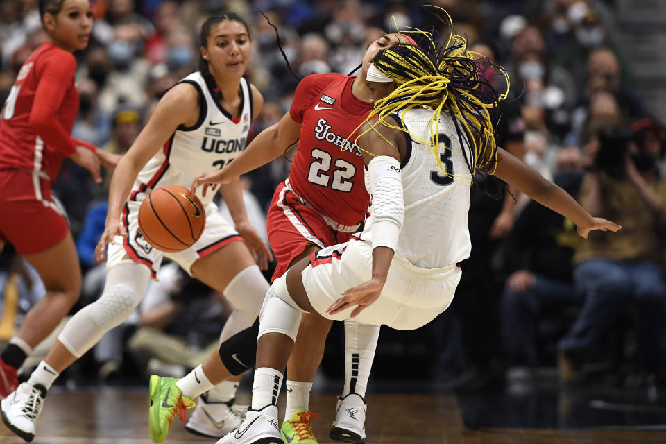 St. John's Camree Clegg (22) is fouled by Connecticut's Aaliyah Edwards (3) in the first half of an NCAA college basketball game, Friday, Feb. 25, 2022, in Hartford, Conn. (AP Photo/Jessica Hill)