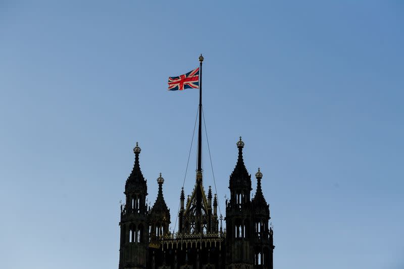 The British union flag flutters on the Victoria Tower at the Houses of Parliament, in London