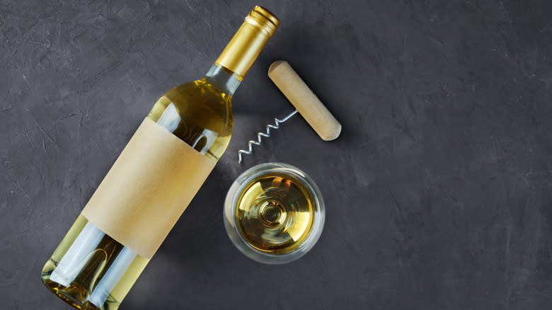white wine, corkscrew and glass