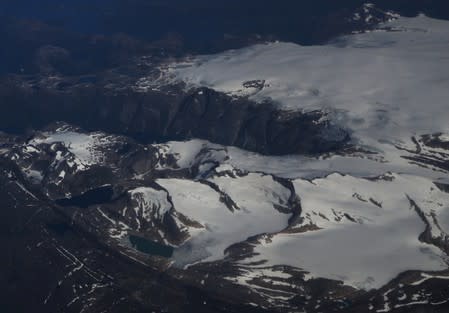 Snow-covered mountains are seen from an atmospheric research aircraft en route to the Norwegian Sea from northern Sweden