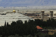 Buildings stand at Al-Maghtas, known as Bethany Beyond the Jordan, on the east bank of the Jordan River in Jordan on Wednesday, June 8, 2022. (AP Photo/Raad Adayleh)