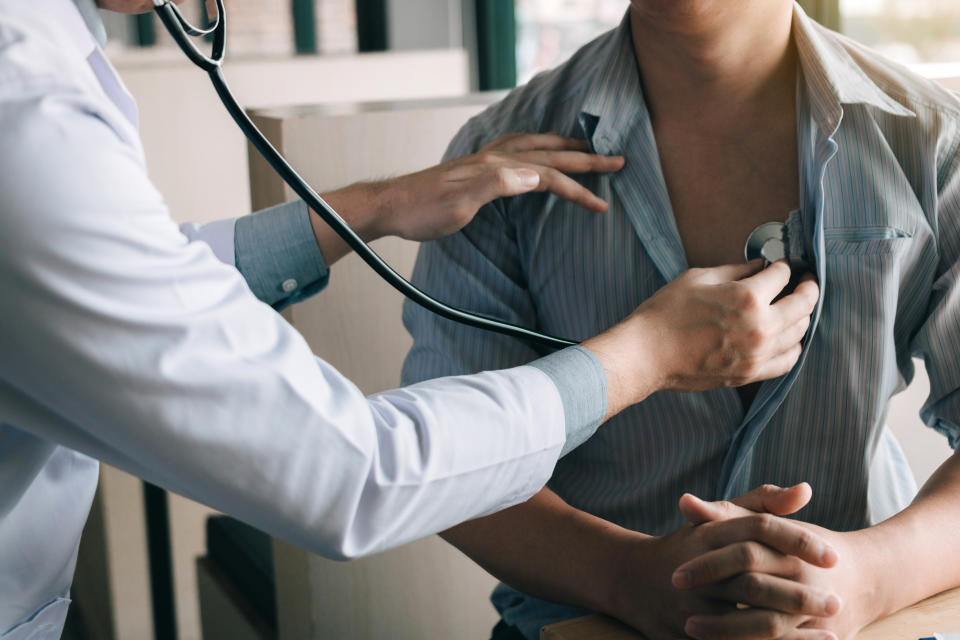 Doctor is using a stethoscope listen to the heartbeat of the elderly patient.