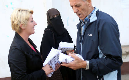 Indira Sinanovic, first Bosnian woman wearing the niqab to run in local election in Bosnia, shares promotional material with colleagues in Zavidovici, Bosnia and Herzegovina, September 27, 2016. REUTERS/Dado Ruvic