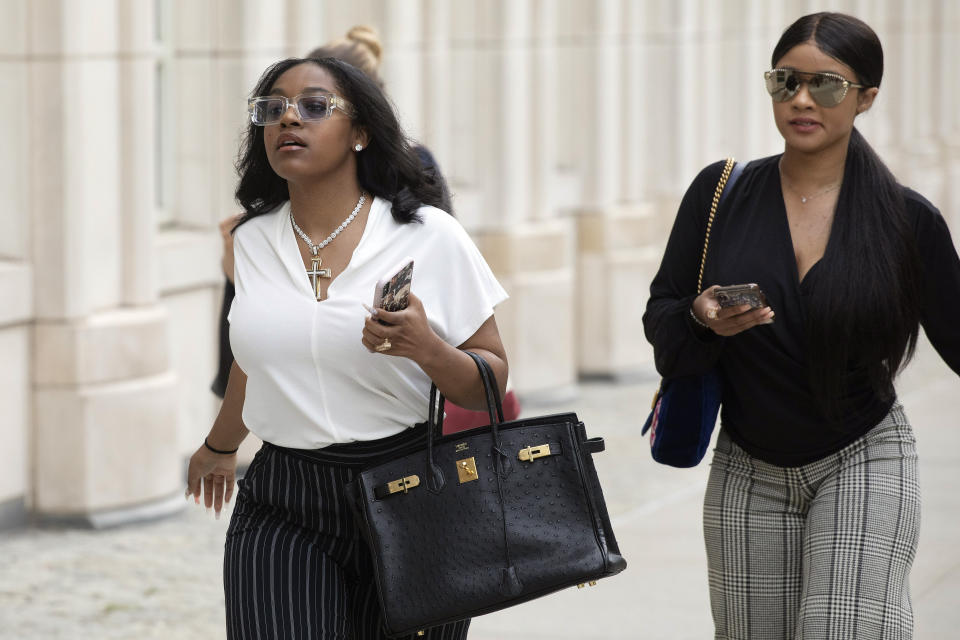 Azriel Clary, left, and Joycelyn Savage, right, two women who lived in Chicago with R&B singer R. Kelly, arrive at Brooklyn federal court for his arraignment, Friday, Aug. 2, 2019 in New York. Kelly faces charges he sexually abused women and girls. (AP Photo/Mark Lennihan)