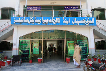 A man stands at the entrance of Government Al-Aziz Hospital, previously known as Al-Aziz Hospital, run by the Islamic charity organisation Jamaat-ud-Dawa (JuD) in Muridke near Lahore, Pakistan February 15, 2018. Picture taken February 15, 2018. REUTERS/Mohsin Raza