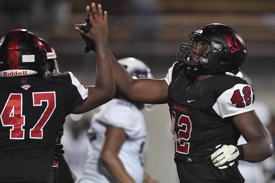 Soutern Durham’s Isaiah Campbell (42) congratulates Elisha Roberts (57) after a play during the first half. The Southern Durham Spartans and the Hillside Hornets met in a non-conference football game at Durham County Stadium on August 25, 2023. Steven Worthy/newsobserver.com