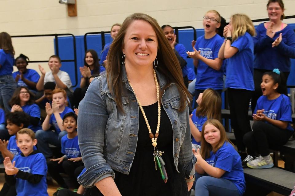 Angela Fowler, a fourth grade math teacher at Grassy Creek Elementary school, walks to accept the Milken Educator Award that includes a $25,000 check on Nov. 22, 2020 in Greenwood, IN.