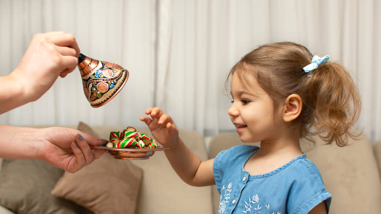 child reaching for mint candy