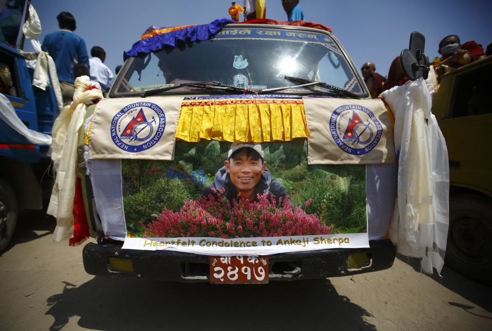 A portrait of Ankaji Sherpa, who lost his life in an avalanche in Mount Everest last Friday, is seen on a truck carrying his body during a funeral rally of Nepali Sherpa climbers in Kathmandu April 21, 2014. (REUTERS/Navesh Chitrakar)