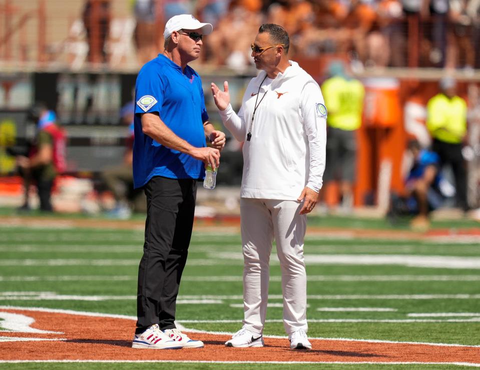 Kansas Jayhawks head coach Lance Leipold, left, talks to Texas Longhorns head coach Steve Sarkisian before their game at Royal-Memorial Stadium on Saturday September 30, 2023.