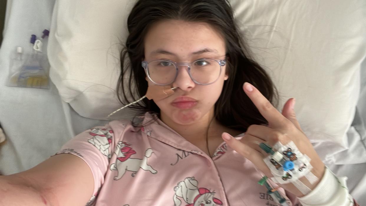 Gabriella Boyd laying in hospital bed while getting treatment for her bowel condition