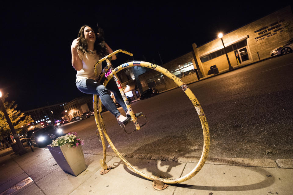 Reporter Jenna Amatulli rides a bike sculpture&nbsp;in front of the HandleBar.