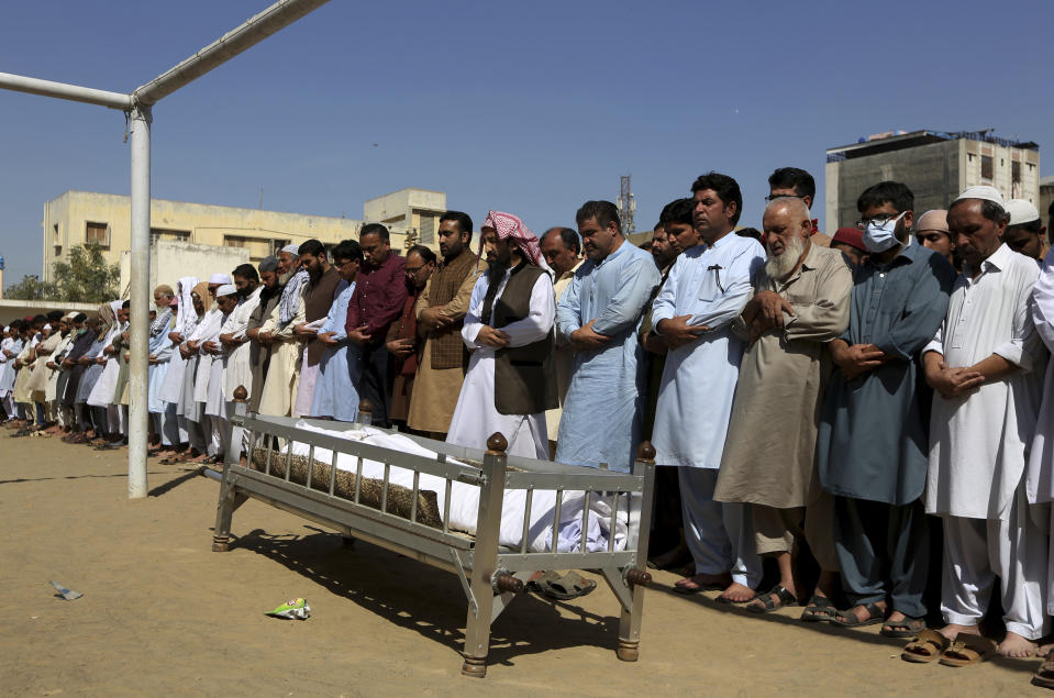 People offer funeral prayers for a victim of a toxic gas leak, during his funeral prayer, in Karachi, Pakistan, Monday, Feb. 17, 2020. The toxic gas leak killed several people and sickened dozens of others in a coastal residential area in Pakistan's port city of Karachi, police said Monday. The source of the leak, which occurred on Sunday night, and the type of gas that had leaked were not immediately known. There was no suspicion of sabotage. (AP Photo/Fareed Khan)