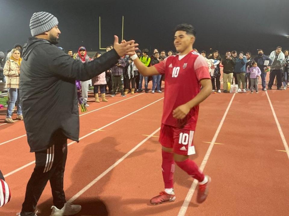 Hueneme senior Andres Gutierrez is congratulated by head coach David Nava after scoring four goals Monday in a 5-0 win over visiting Fillmore on Senior Night.