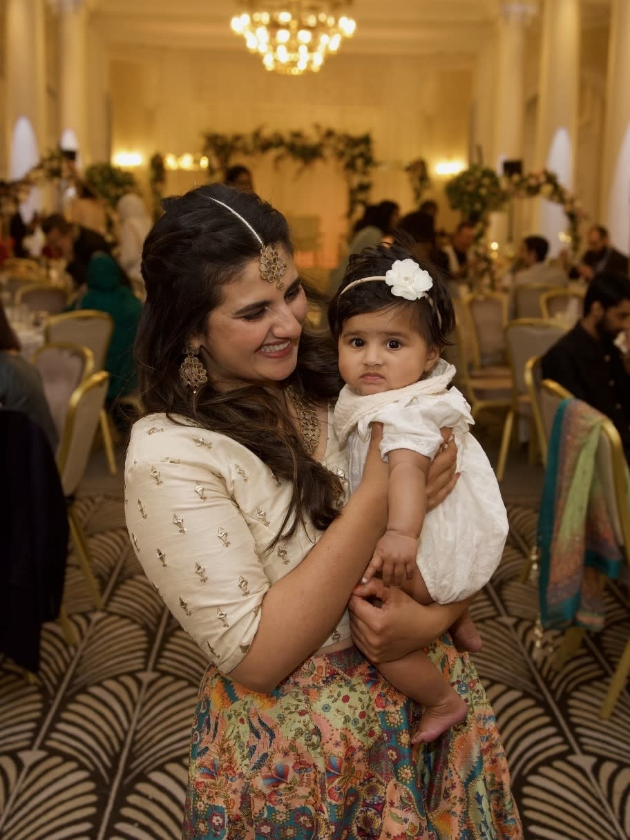 Sahar Aman at her brother's wedding with her daughter of six months. 