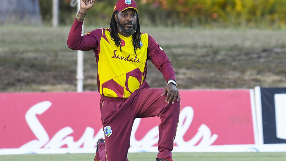 Chris Gayle kneels prior to a cricket match for the West Indies.