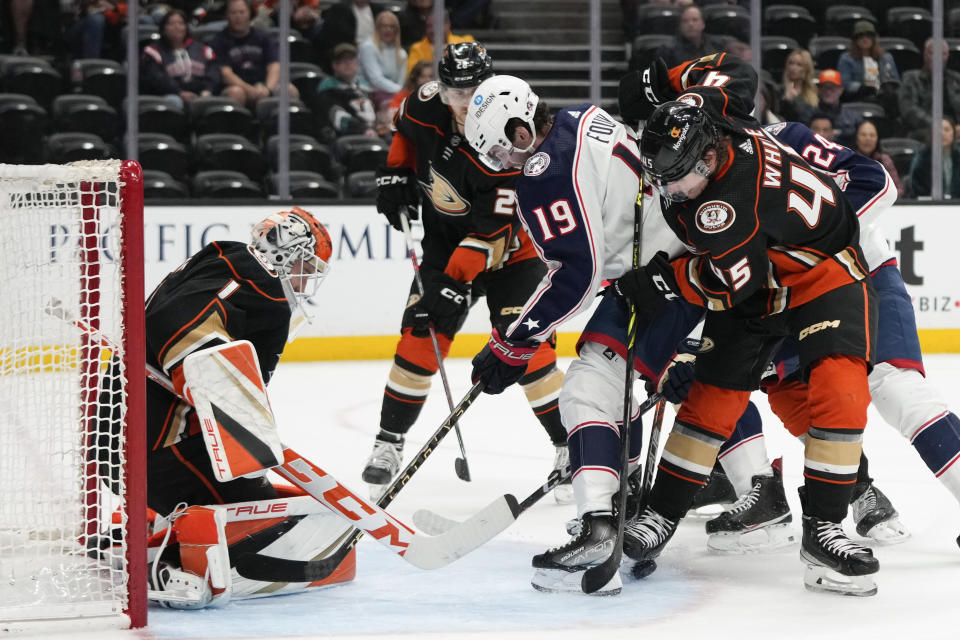 Anaheim Ducks goaltender Lukas Dostal (1) makes a save against Columbus Blue Jackets' Liam Foudy (19) during the second period of an NHL hockey game Friday, March 17, 2023, in Anaheim, Calif. (AP Photo/Jae C. Hong)