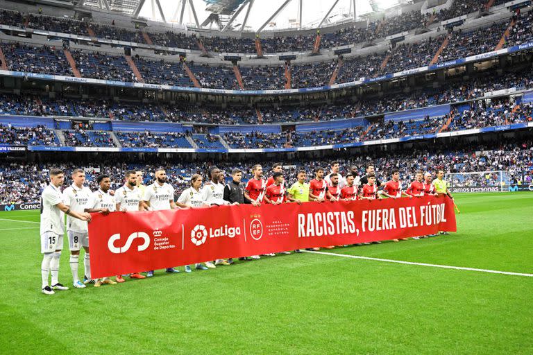 "Racistas, fuera del fútbol", la pancarta que exhibieron los jugadores de Real Madrid y Rayo Vallecano antes del partido, en apoyo a Vinicus.