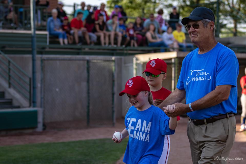 Emma Mertens, a 7-year-old from Wisconsin, threw out the first pitch at her brother's baseball game a day after emergency surgery.