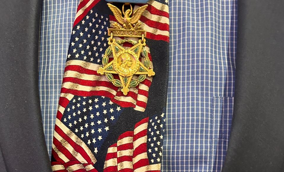 Gary Littrell wears his Congressional Medal of Honor over his patriotic American flag necktie.