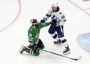 Tampa Bay Lightning' Mikhail Sergachev (98) and Dallas Stars' Jason Dickinson (18) rough it up during first-period NHL Stanley Cup finals hockey game action in Edmonton, Alberta, Monday, Sept. 28, 2020. (Jason Franson/The Canadian Press via AP)