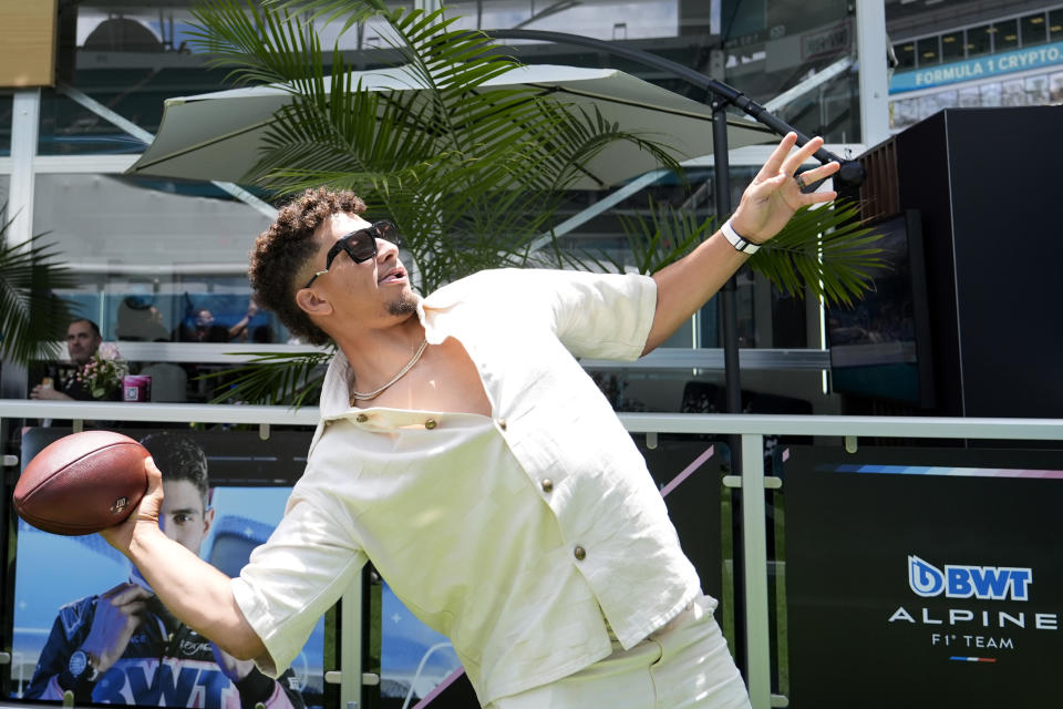 Kansas City Chiefs NFL quarterback Patrick Mahomes prepares to throw a football outside of the Alpine hospitality area at the Miami Formula One Grand Prix auto race Sunday, May 5, 2024, in Miami Gardens, Fla. (AP Photo/Lynne Sladky)