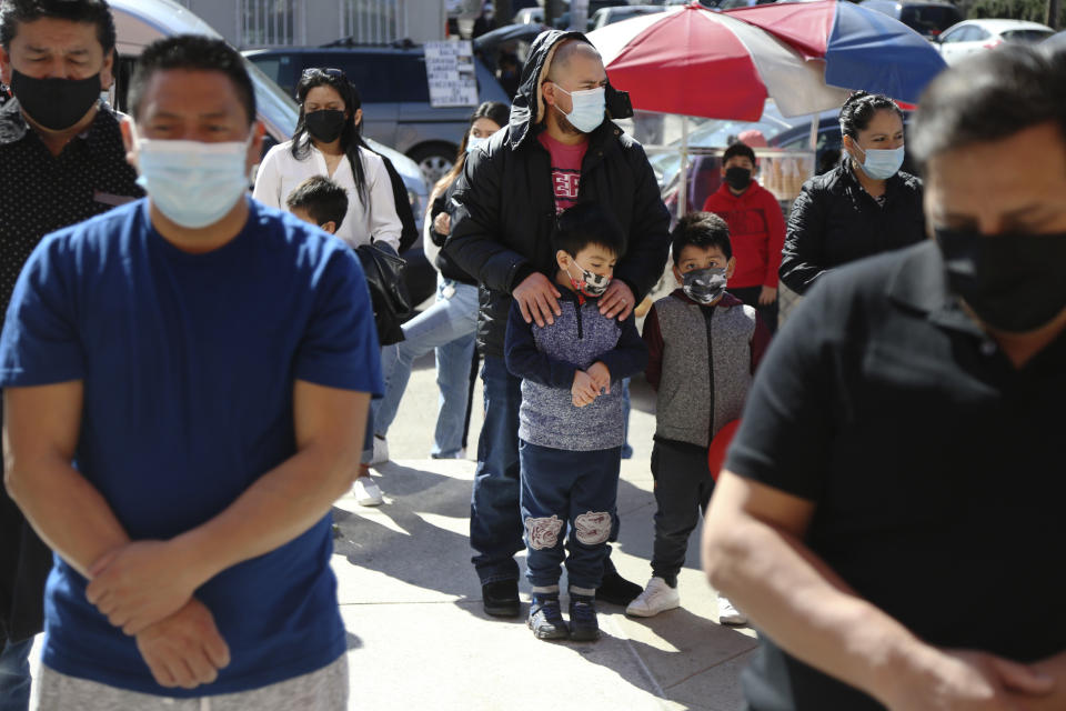 Parishioners attend a Mass relayed via loudspeaker outside Our Lady of Sorrows in the Queens borough of New York on Sunday, March 21, 2021. The Rev. Manuel Rodriguez says more than 100 parishioners of the Roman Catholic church have died from COVID-19. (AP Photo/Jessie Wardarski)