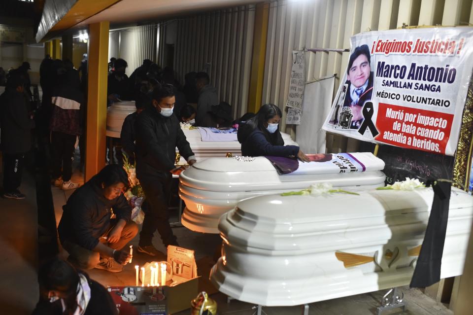 Residents hold a vigil for the more than a dozen people who died during the unrest in Juliaca, Peru, Tuesday, Jan. 10, 2023. At least 17 people died Monday in southeast Peru as protests seeking immediate elections resumed in neglected rural areas of the country still loyal to ousted President Pedro Castillo. (AP Photo/Jose Sotomayor)